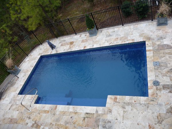 Travertine pool coping around inground pool