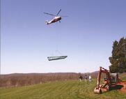 helicopter delivering a fiberglass pool