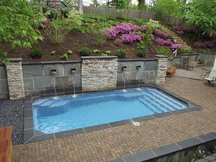 Fiberglass pool with retaining wall