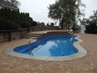 Fiberglass pool with retaining wall