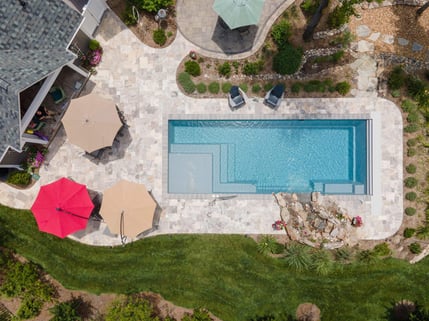 004. River Pools M35 in Granite Gray with a cascade, natural stone patio, and concrete paver coping