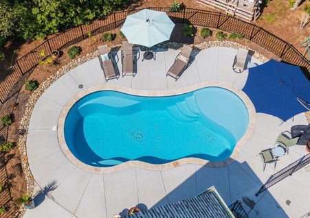 015. River Pools I30 in Caribbean Sparkle with brushed concrete and natural stone coping-1