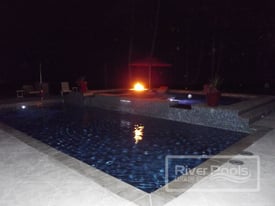 Pool and fire pit at night