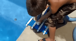 kid-vacuuming-inground-pool