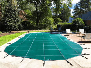 Pool cover over inground pool - is it time to winterize your swimming pool?