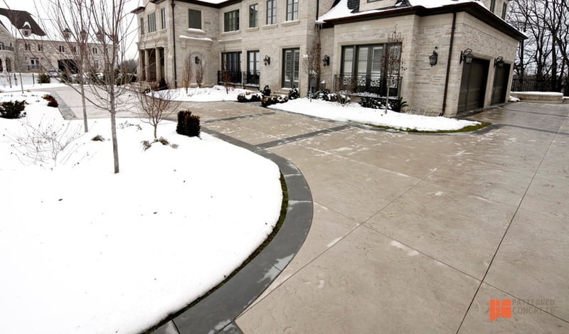 snowy house and stamped concrete