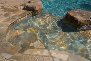 Stone tile on a concrete pool 