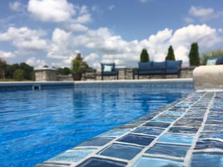 Blue glass tile on a pool tanning ledge