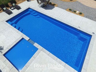 G36 fiberglass pool with tanning ledge built into the patio