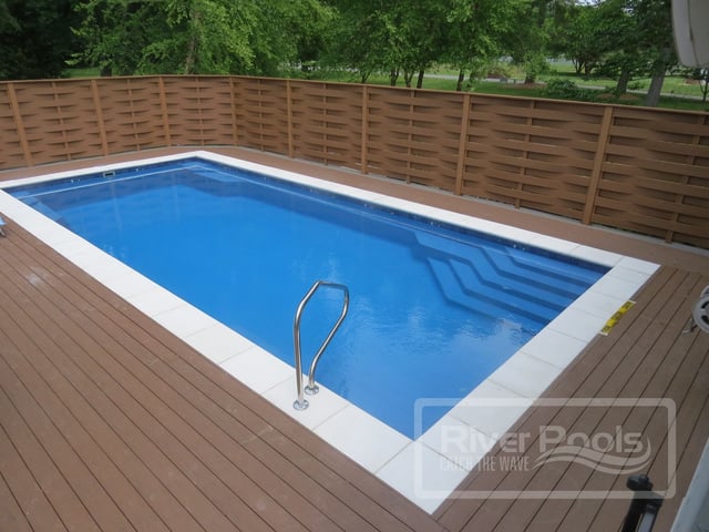 Inground fiberglass pool with wooden deck
