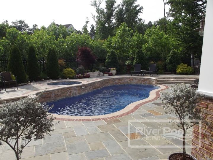 freeform fiberglass pool with elevated spa