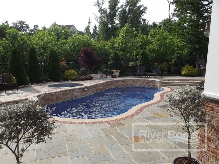 freeform fiberglass pool with elevated spa