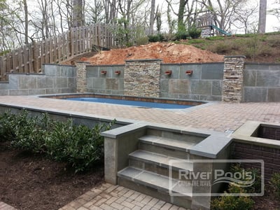 retaining wall on top and bottom for pool on a sloped yard