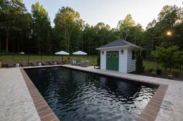 black bottom swimming pool with pool house