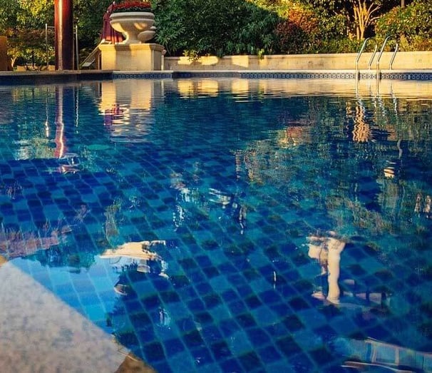 dark blue tiled swimming pool