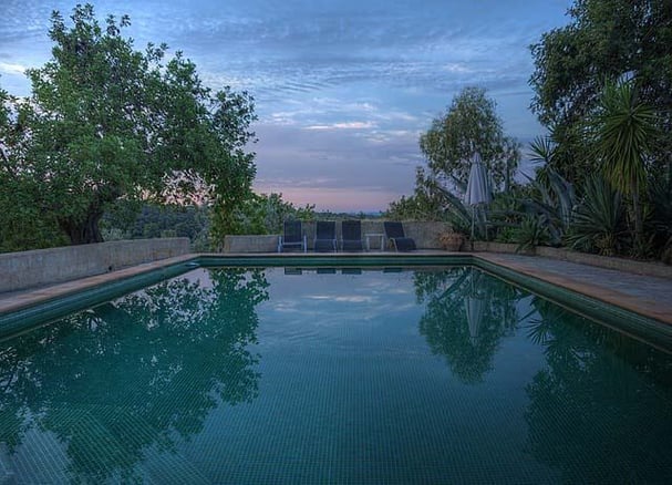 emerald green tiled dark bottom pool