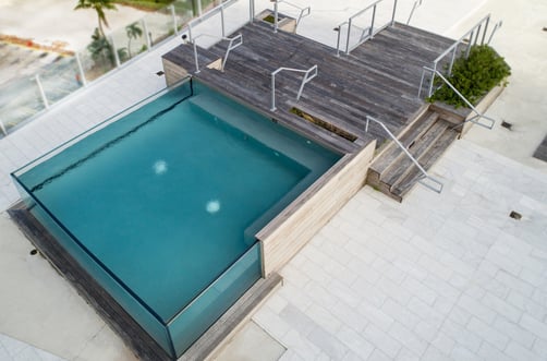 Glass walls around concrete pool