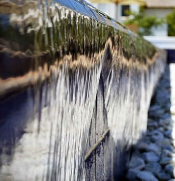 infinity edge pool with water cascading over the side