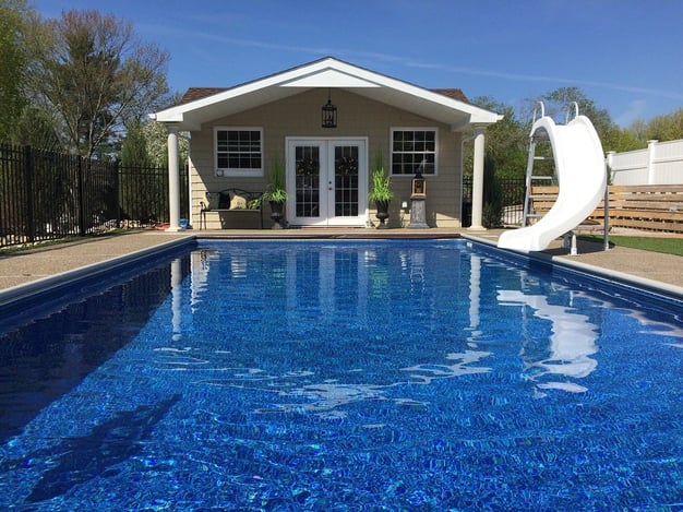 pool house with porch and windows