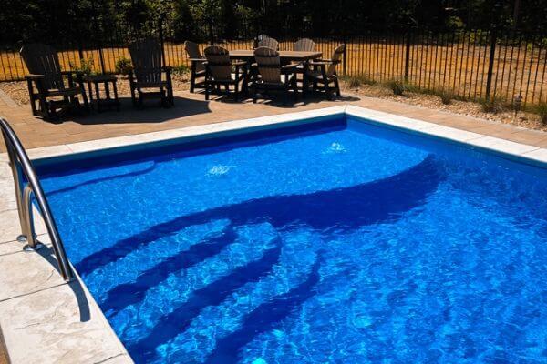 small inground pool with tanning ledge