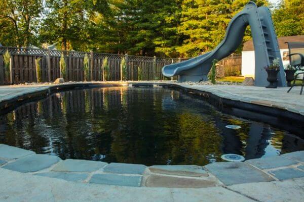 black bottom fiberglass pool with slide