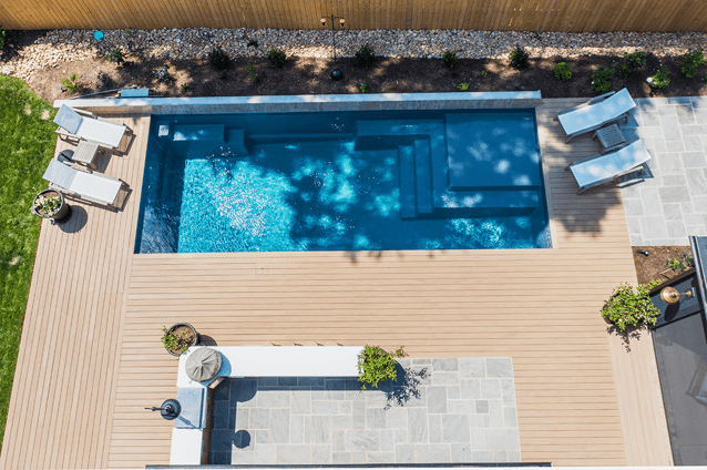 Aerial image of rectangle M35 pool model by River Pools featuring square and rectangular steps, tanning ledge and benches.