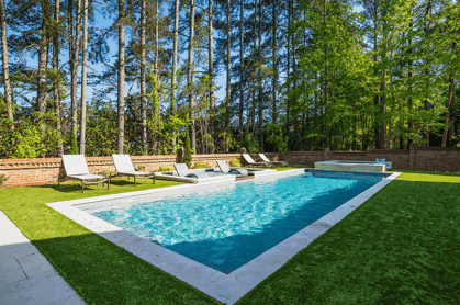 Image of R40 rectangle fiberglass pool by River Pools surrounded by trees. 