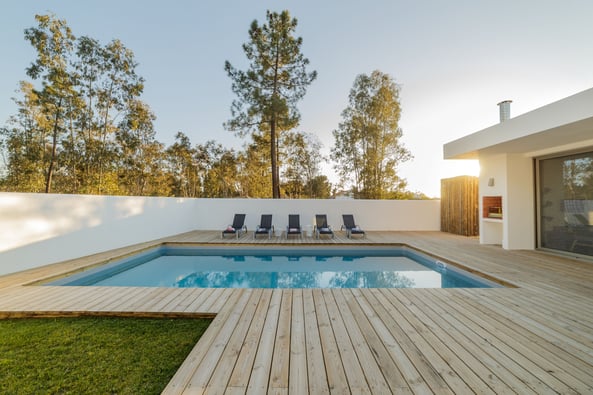 Wooden deck around inground pool 