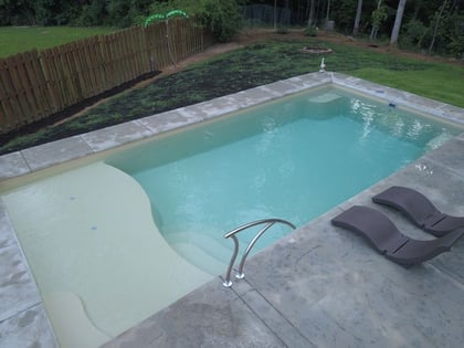 D Series pool in sandstone shimmer with concrete patio