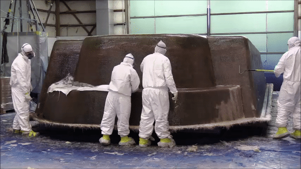Manufacturers applying woven roving to fiberglass pool