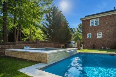 River Pools R40 + SS08 with spillway + TL15 with spillway in Granite Gray with bubblers, turf patio and natural stone coping 7