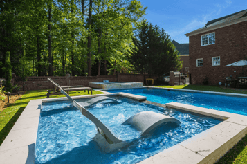River Pools R40 + SS08 with spillway + TL15 with spillway in Granite Gray with bubblers, turf patio and natural stone coping 6