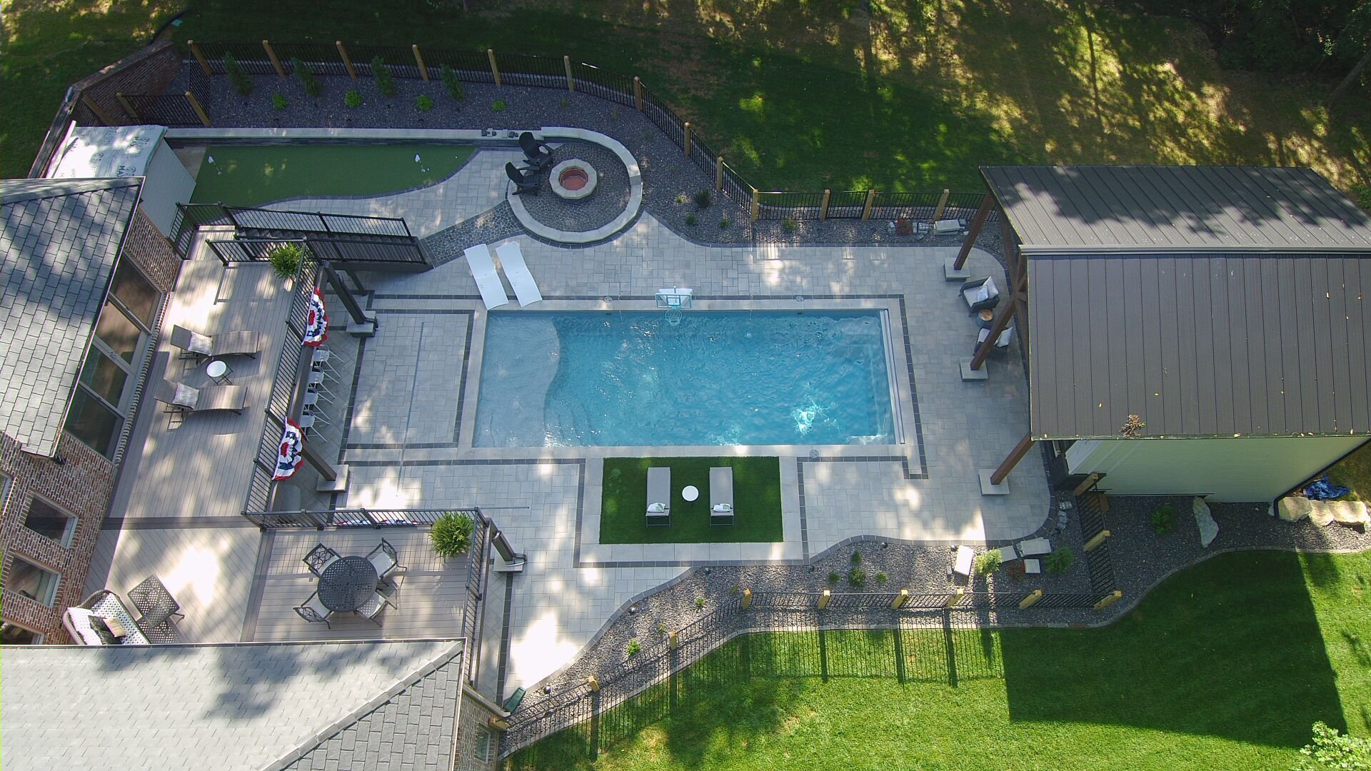 Fiberglass pool installation in Springfield, MO with loungers, fire pit, and private backyard layout