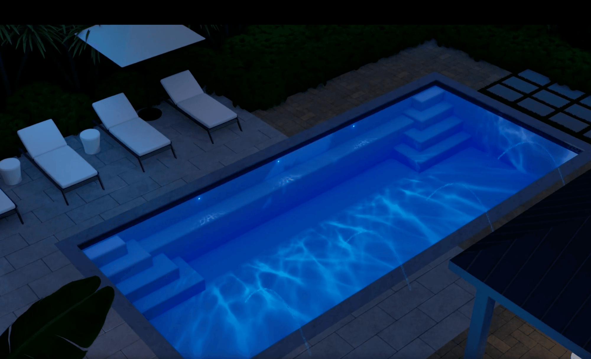 A36 fiberglass pool installed in a modern backyard with in-pool lighting, wide entry steps, and surrounding lounge area for evening relaxation and entertaining.