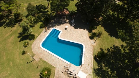 Aerial view of L-shaped concrete pool