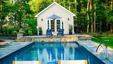 T40 pool in Granite grey with blue and grey waterline tile and natural stone patio