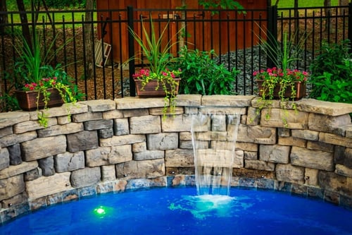cascade built into a retaining wall for O30 fiberglass pool