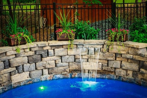 cascade built into a retaining wall for O30 fiberglass pool