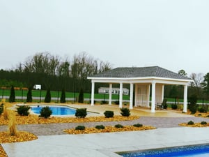 fiberglass pool with a permanent pavilion on the patio