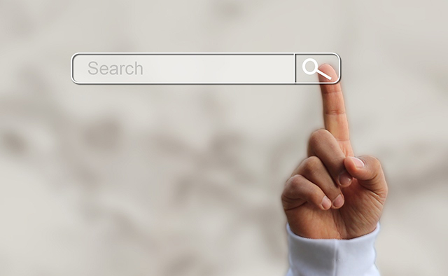 Finger pressing on search icon.