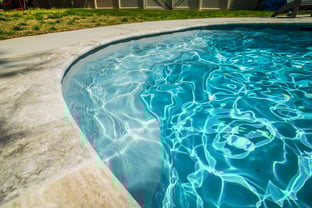 River Pools C35 in Diamond color with brushed concrete and natural stone coping