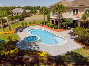 River Pools C40 + RS08 with spillway in Caribbean Sparkle with concrete paver patio and natural stone coping