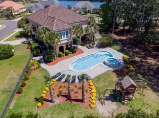 River Pools C40 + RS08 with spillway in Caribbean Sparkle with concrete paver patio and natural stone coping
