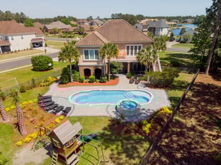 River Pools C40 + RS08 with spillway in Caribbean Sparkle with concrete paver patio and natural stone coping