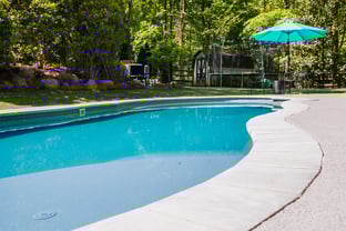  River Pools C40 in Maya Shimmer with brushed concrete and natural stone coping