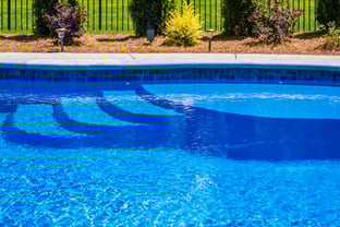 River Pools C40 in Maya Shimmer with brushed concrete and natural stone coping