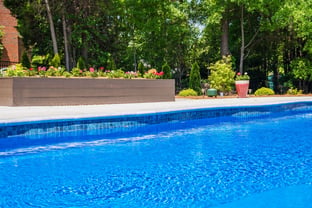 River Pools C40 in Maya Shimmer with brushed concrete and natural stone coping