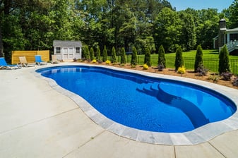 River Pools C40 in Maya Shimmer with brushed concrete and natural stone coping