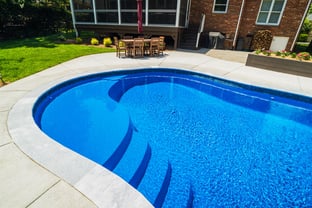 River Pools C40 in Maya Shimmer with brushed concrete and natural stone coping