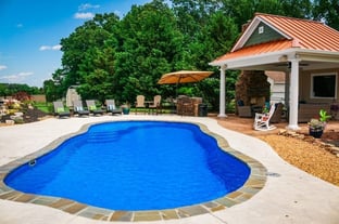 C40 Series pool in maya blue with a pool house